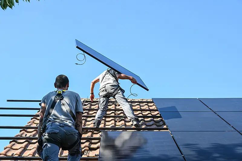 Solar panel installers on roof